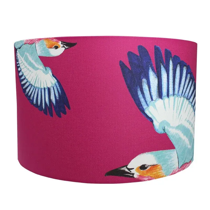 Safari Bird lampshade: a cherry pink drum shade with lilac-breasted rollers in flight, wings in blue and turquoise