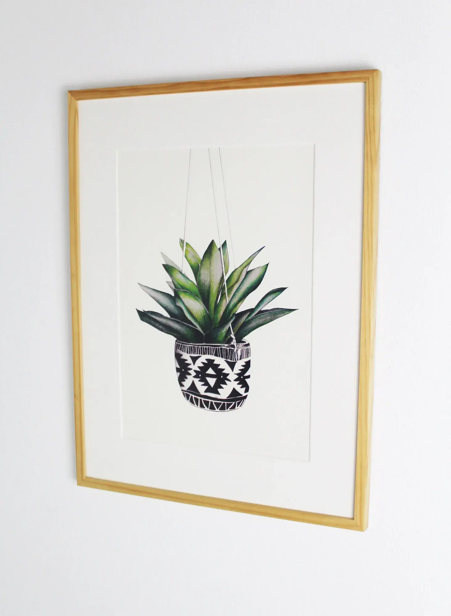 Succulent A4 art print: a green succulent in a black and white Aztec-patterned pot, in a gold frame