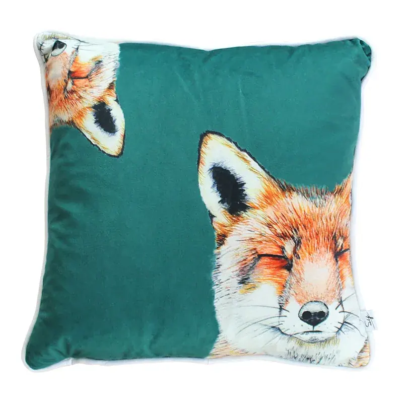Urban Fox velvet cushion: a hand-drawn red fox dozing with its eyes closed, and a second fox peeking in from the top corner, on jade green velvet with white piping
